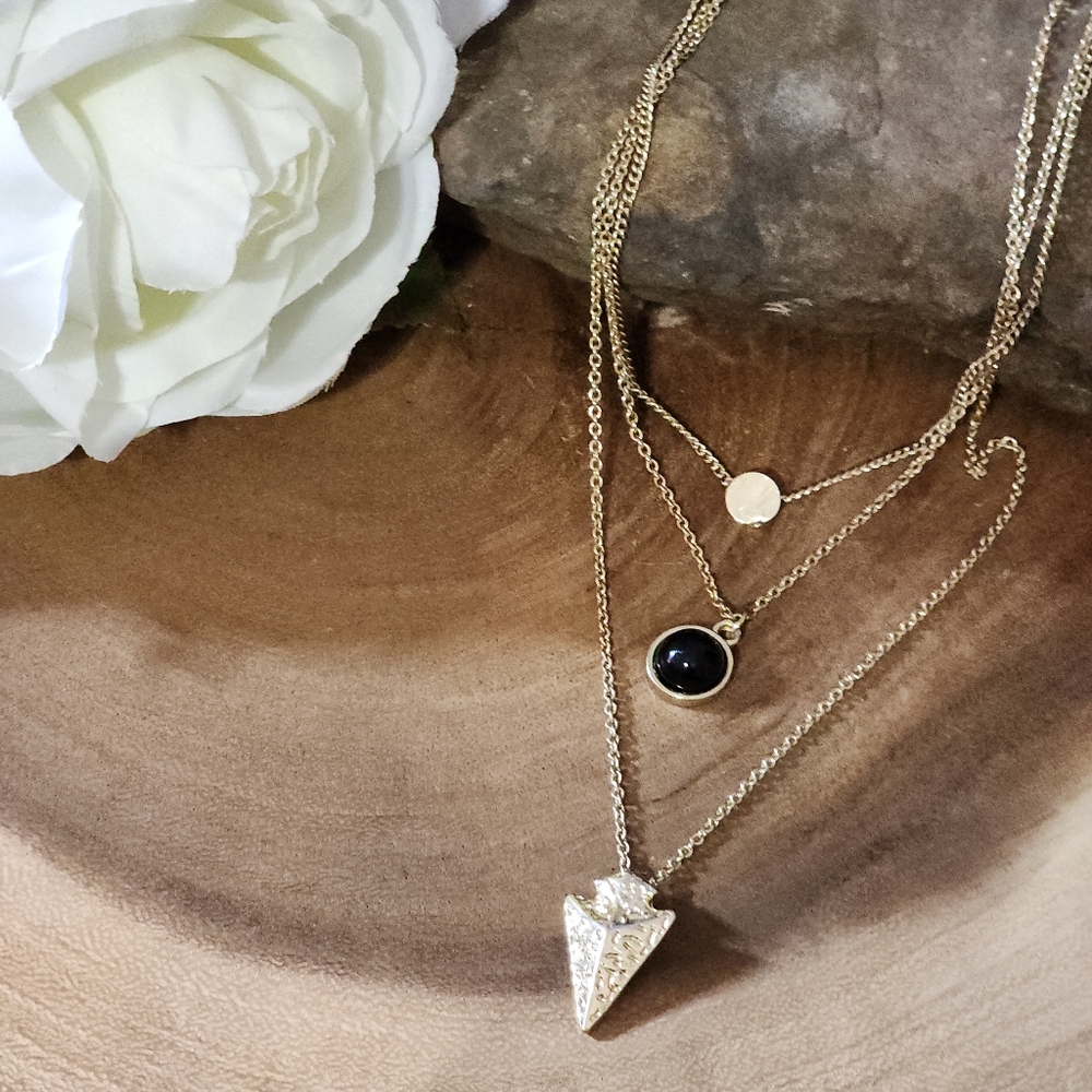 Gold Toned Triple Layered Necklace With Black Bezel Bead, Arrowhead, And Charm